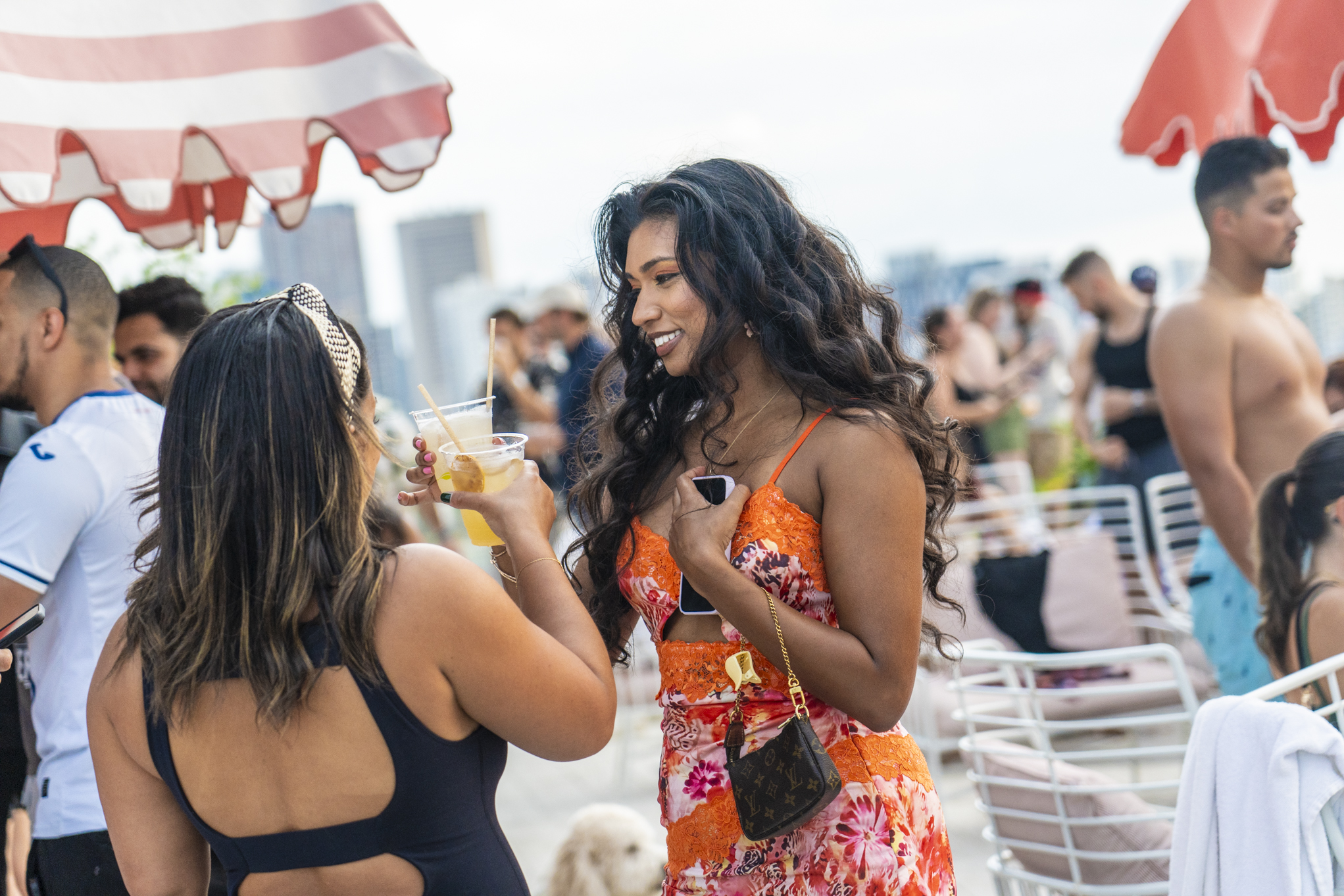 Two women conversing with drinks at a party at ART Wynwood